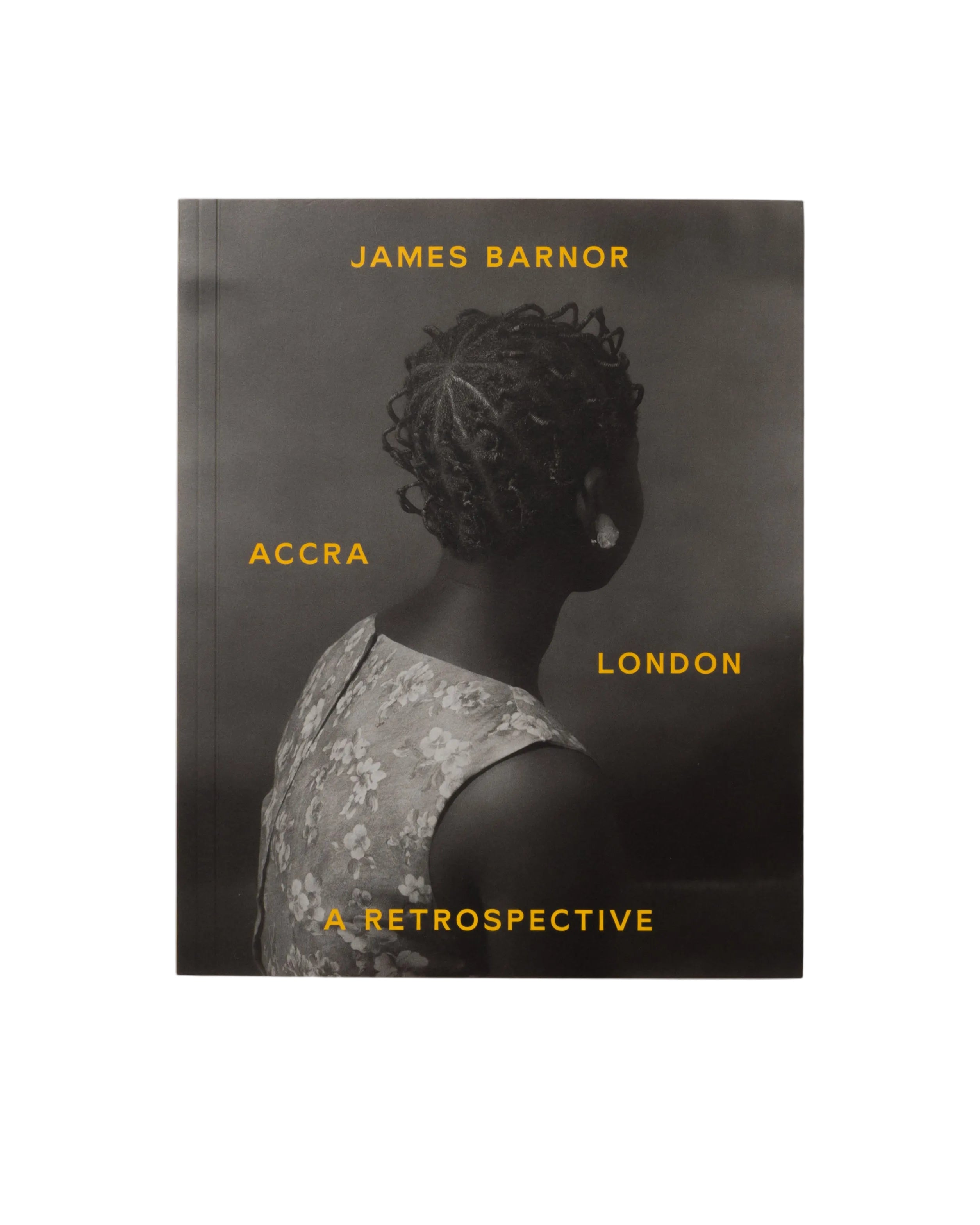 Cover of the catalogue for James Barnor's solo exhibition 'Accra / London - A Retrospective', featuring a black and white photograph of a person from behind, with the artist and exhibition title text.