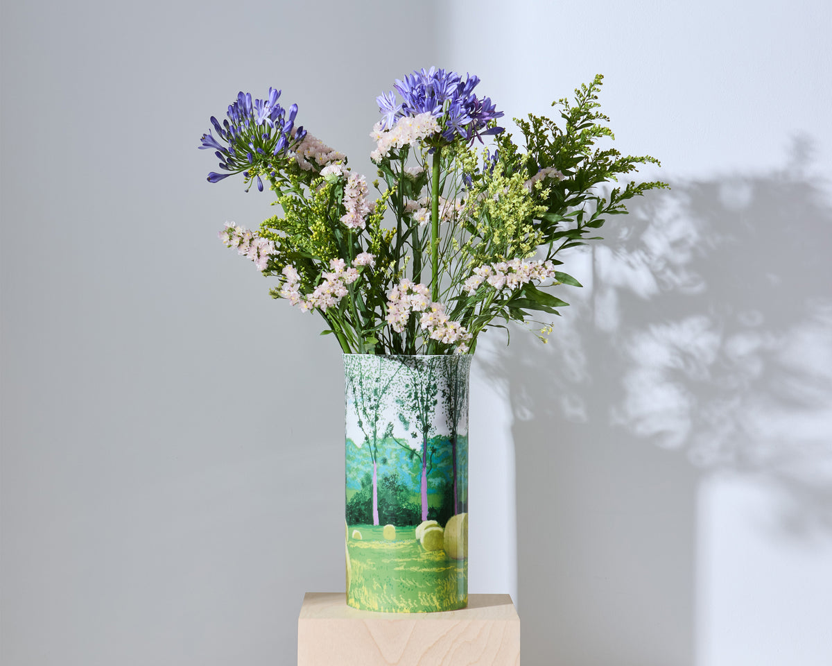 Vase with flowers on a light gray background