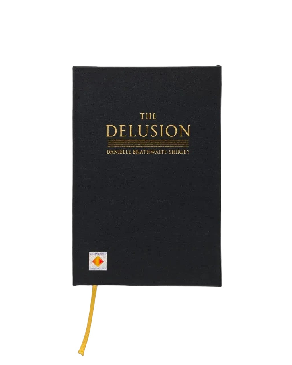 A black hardcover journal titled 'THE DELUSION' by Danielle Brafton-Grillet, featuring gold lettering and a small orange-and-white logo near the bottom left, with a yellow ribbon bookmark hanging from the lower edge, set against a plain white background.