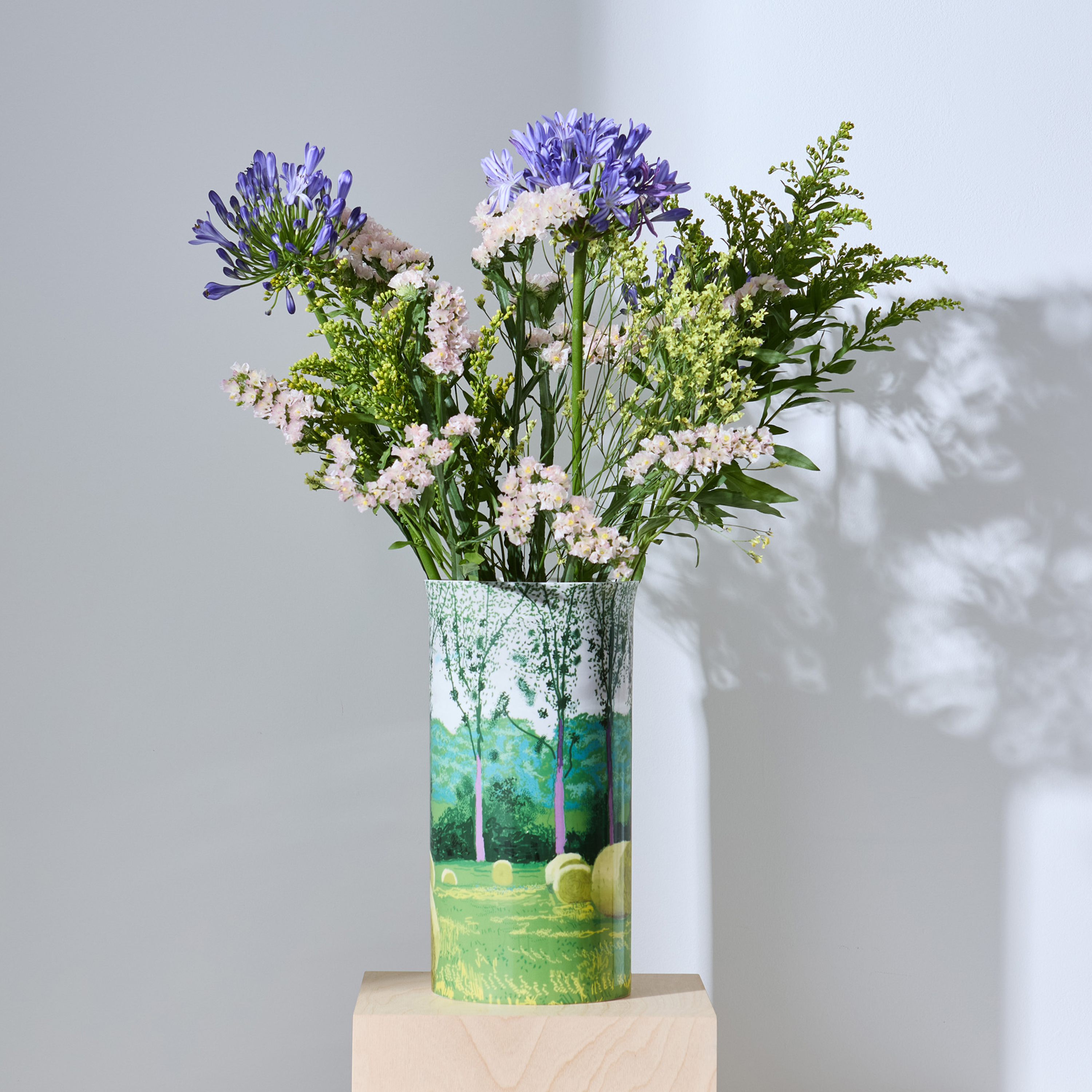 Vase with flowers on a light gray background